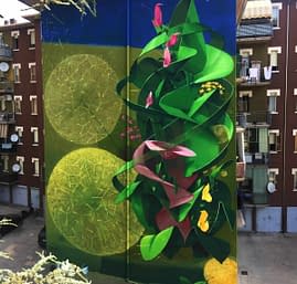 Big wall painting on building with green leaves and pink flowers. Total building view. Aerosol art by Dado