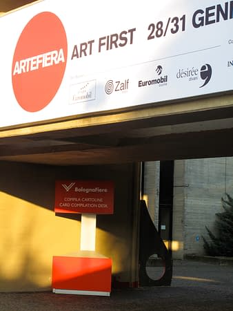 Close view of the main entrance of ArteFiera the annual Art fair of the city of Bologna with a "D" sculpture installed in the background