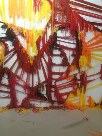 A closeup detail of the skeleton of a wool made graffiti in the tones of yellow, orange and various reds, after being ripped. Artworks by Dado