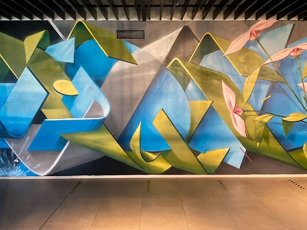 Detail of a wall decoration representing intersecting blue ,green and gray ribbons in a sophisticated geometrical pattern. Aerosol art by Dado.