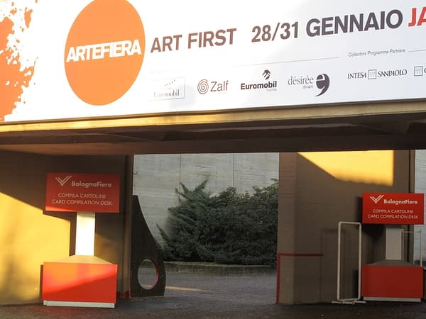 Wide view of the main entrance of ArteFiera the annual Art fair of the city of Bologna with a "D" sculpture installed in the background