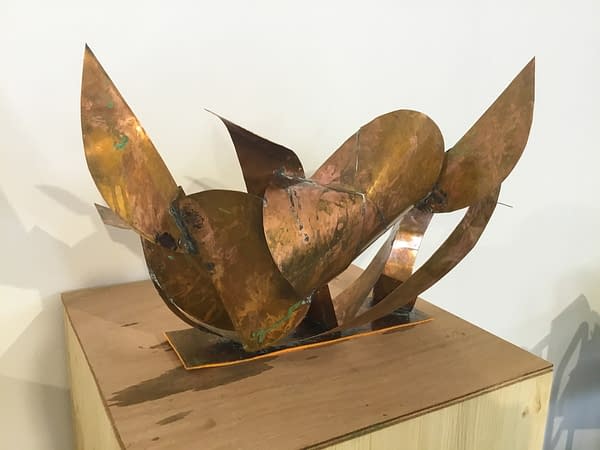 A sculpture made of bent and torched copper ribbons in original copper color with slightly different copper tones and some oxidation stains, back view. Artwork by Dado