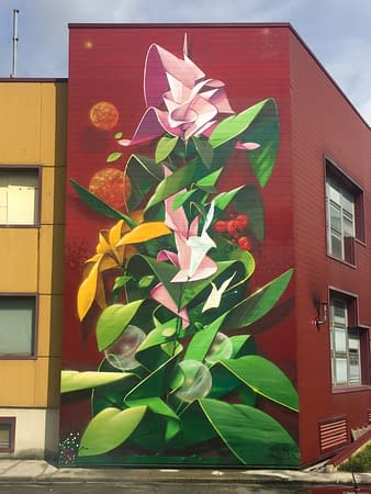 Total view of a big wall mural painting representing a ribbon wildstyle lettering various colored flowers spherical Dandelion seedheads and green leaves. Artwork by Dado.