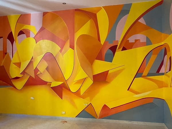 Total view of an interior wall decoration representing an abstraction of Bologna's arcs, Portici in yellow-orange tones. Artwork by Dado.
