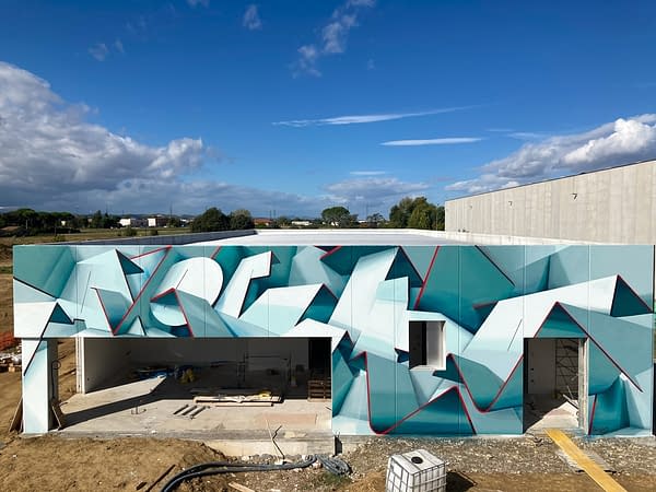 Total front view of a graffiti paint work on the external walls of a big building representing flat ribbons bent in geometrical shapes, light blue and white shades with thin red outlines. Artwork by Dado