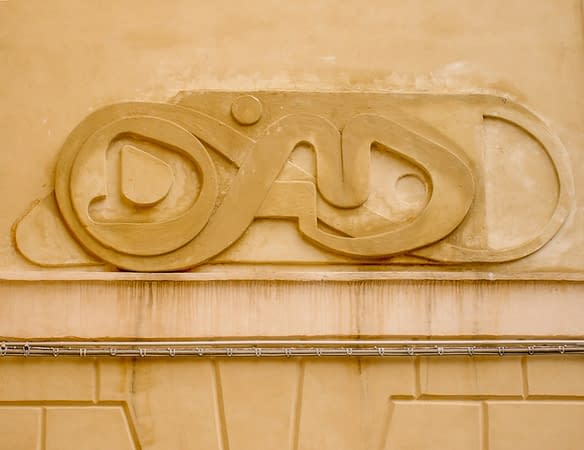 Bas-relief sculpture in a contemporary graffiti lettering fixed on a above a Medieval vault architecture well pairing. Front view detail. Artwork by Dado