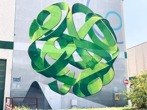 Total view of a mural painting depicting a spherical wildstyle graffiti forming the tag Dado in green tones.