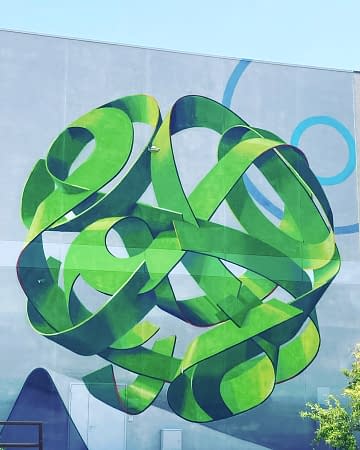 Main element of a mural painting depicting a spherical wildstyle graffiti forming the tag Dadoi green tones.