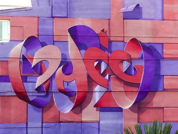 Detail of a mural depicting floating bent ribbons creating two names altogether the tag Dado and the name Eva in a pale red and electric blue tones