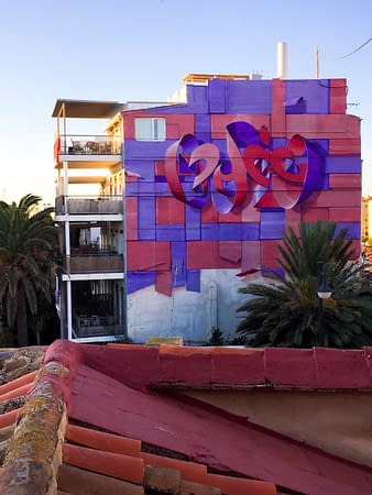 An high building at the dawn with a big mural painting depicting floating bent ribbons creating two names altogether the tag Dado and the name Eva in a pale red and electric blue tones